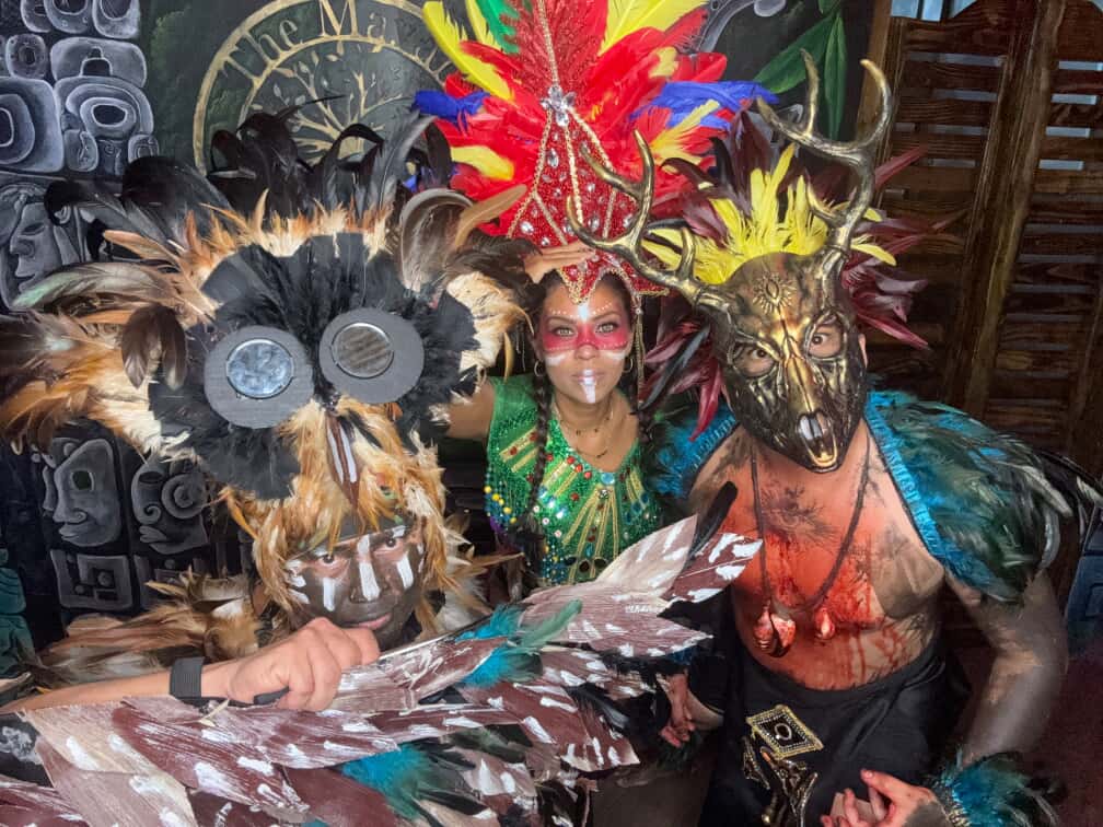 Maya cultural performers in elaborate costumes and masks
